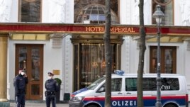 Police officers stand in front of Hotel Imperial where a delegation from Iran is staying in Vienna, Austria, Tuesday, April 6, 2021. (AP Photo/Florian Schroetter)