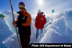 A guide leads U.S. Secretary of State John Kerry through the zone where ice crashes into land outside Scott Base, the New Zealand research station in the Antarctic, Nov. 12, 2016,