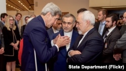 U.S. Secretary of State John Kerry speaks with Hossein Fereydoun, the brother of Iranian President Hassan Rouhani, and Iranian Foreign Minister Javad Zarif, in Vienna, Austria, July 14, 2015.