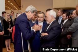 U.S. Secretary of State John Kerry speaks with Hossein Fereydoun, the brother of Iranian President Hassan Rouhani, and Iranian Foreign Minister Javad Zarif, in Vienna, Austria, July 14, 2015.