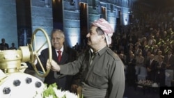 KRG president Massud Barzani, right, and Iraqi President Jalal Talabani open a ceremonial valve during an event to celebrate the start of oil exports from the autonomous region of Kurdistan, Irbil, Iraq, June 1, 2009.