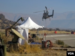 Two controllers on the group put the K-MAX unmanned chopper through its paces. (Credit: Tom Banse)