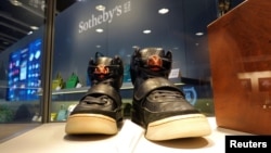 FILE: A pair of 'Nike Air Yeezy 1' prototype sneakers designed by Kanye West, are displayed at the Hong Kong Convention and Exhibition Centre before going up for private sale at Sotheby's, in Hong Kong. Taken April 16, 2021. 