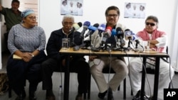 FILE - Chief negotiator of the Revolutionary Armed Forces of Colombia, or FARC, Ivan Marquez, second right, talks to reporters during a press conference in Bogota, Colombia, Dec. 6, 2016. 