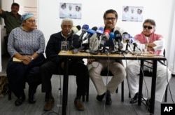 FILE - Chief negotiator of the Revolutionary Armed Forces of Colombia, or FARC, Ivan Marquez, second right, talks to reporters during a press conference in Bogota, Colombia, Dec. 6, 2016.