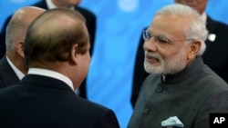 Indian Prime Minister Narendra Modi, right, speaks to Prime Minister of Pakistan Muhammad Nawaz Sharif, in Ufa, Russia, July 10, 2015.