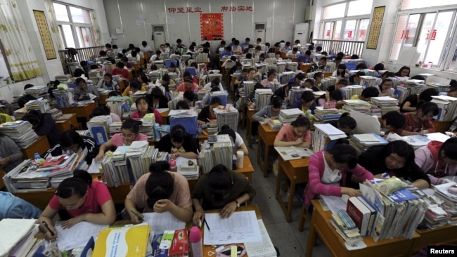 In this June 2, 2012 photo, students prepare for the university entrance exam in a classroom in Hefei, Anhui Province. If you read the room here, what would the mood be? (REUTERS/Stringer)