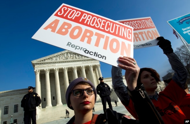 FILE - Abortion rights activists protest outside of the U.S. Supreme Court, during the March for Life in Washington, Jan. 18, 2019.