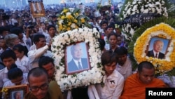 Thousands of mourners gather at the gates of the Royal Palace minutes after the coffin of former king Norodom Sihanouk arrived in Phnom Penh October 17, 2012. 