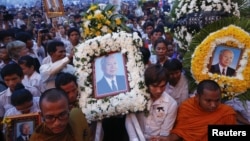 Thousands of mourners gather at the gates of the Royal Palace minutes after the coffin of former king Norodom Sihanouk arrived in Phnom Penh October 17, 2012. Tens of thousands poured into Cambodia's capital to witness the procession on Wednesday.