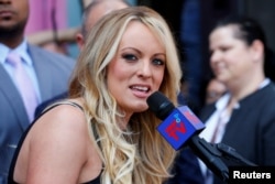 FILE - Stormy Daniels speaks during a ceremony in her honor in West Hollywood, California, May 23, 2018.