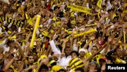 FILE - Fans cheer during a soccer match at King Fahad stadium in Riyadh, Saudi Arbia, May 7, 2010. Saudi authorities announced Sunday an alleged terror cell had planned a car bomb attack outside Al-Jawhara stadium in Jeddah during an October 11 match.