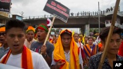 FILE - Activists of All Assam Students' Union (AASU), along with 28 other organizations walk during a protest rally against India’s Citizenship Amendment Bill 2016 in Gauhati, northeastern Assam state, India, June 29, 2018.