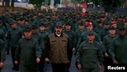 Le président du Venezuela Nicolas Maduro, avec, à sa gauche, le ministre de la Défense, le général Vladimir Padrino Lopez, et l'amiral Remigio Ceballos, commandant stratégique opérationnel de la marine, dans une base militaire à Caracas, le 2 mai 2019. (Reuters)