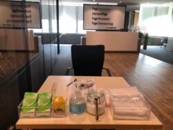 A thermometer, hand sanitizer and masks are pictured in the reception area at PageGroup's office after reopening, as the coronavirus disease (COVID-19) continues, in Shanghai, China, April 29, 2020.