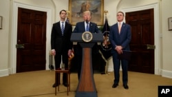President Donald Trump, flanked by Sen. Tom Cotton, R- Ark., left, and Sen. David Perdue, R-Ga., speaks in the Roosevelt Room of the White House in Washington, Aug. 2, 2017, during the unveiling of legislation that would place new limits on legal immigrat
