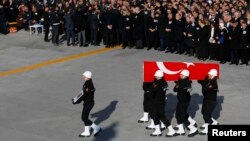 Turkish police officers carry a coffin of a fellow officer during a ceremony for police officers killed in Saturday's blasts in Istanbul, Dec. 11, 2016. 