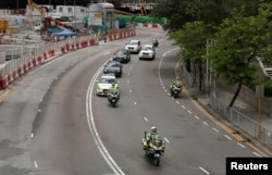 Police take part in a motorcade rehearsal in front of the Hong Kong Convention and Exhibition Center, where Chinese President Xi Jinping will attend a swearing-in ceremony during the 20th anniversary of the territory's handover to Chinese rule in Hong Kong, June 27, 2017.