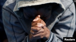 A migrant prays on the Migrant Offshore Aid Station ship Topaz Responder after being rescued around 20 nautical miles off the coast of Libya, June 23, 2016.