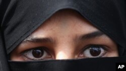 FILE - A veiled Iranian woman attends a rally after the Friday prayers in Tehran, Iran.