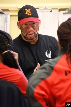 Gerald Smith, student advocate and dean of restorative justice at Chicago's North Lawndale College Prep High School, speaks to students about their disagreement with a teacher, April 19, 2018. Smith also serves as the adult adviser for the school's Peace Warrior group, which aims to prevent violence and interrupt conflict at the school and in the city.