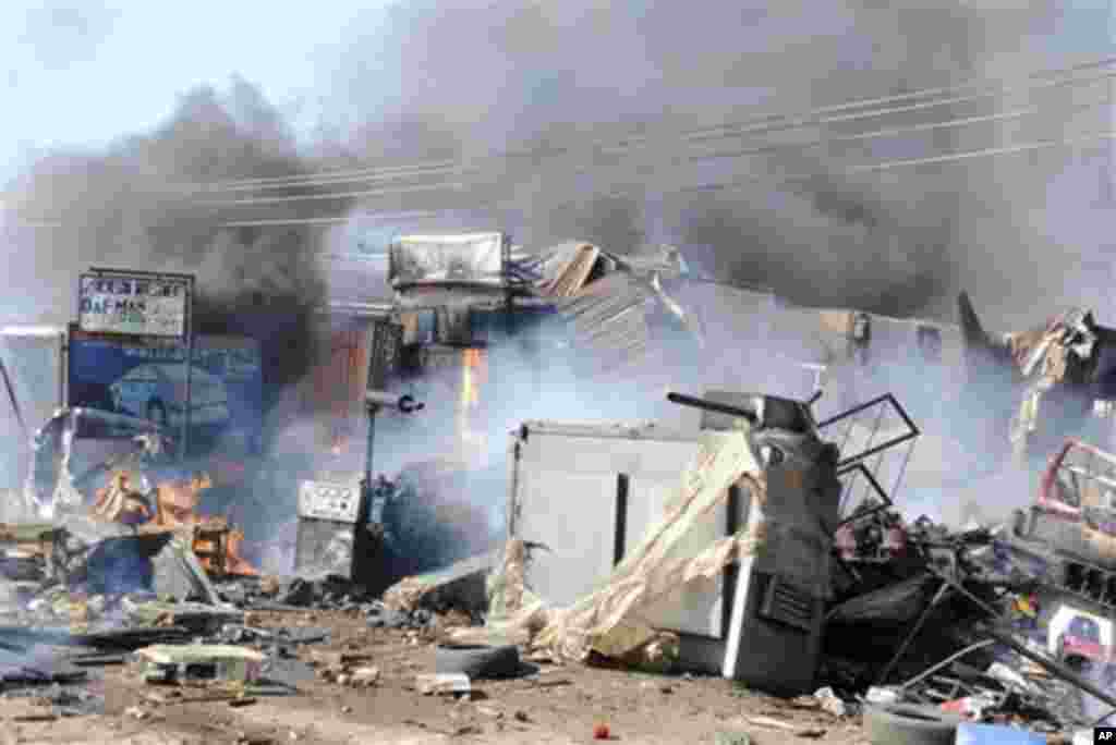 A fire engulfs an auto parts market in Kaduna, Nigeria on Wednesday, Dec. 7, 2011. Emergency officials say at least seven people died in the explosion Wednesday morning in the central Nigerian city that straddles the divide between the country's largely C
