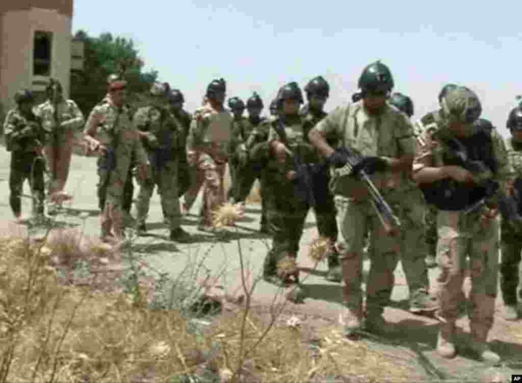 This image taken from video obtained from the Iraqi Military shows Iraqi soldiers during clashes with militants in the northern city of Mosul, Iraq, June 9, 2014.