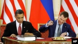 U.S. President Barack Obama and Russian President Dmitry Medvedev sign START treaty in 2010. (File) “Implementation is going smoothly behind the scenes,” said Ms. Gottemoeller.