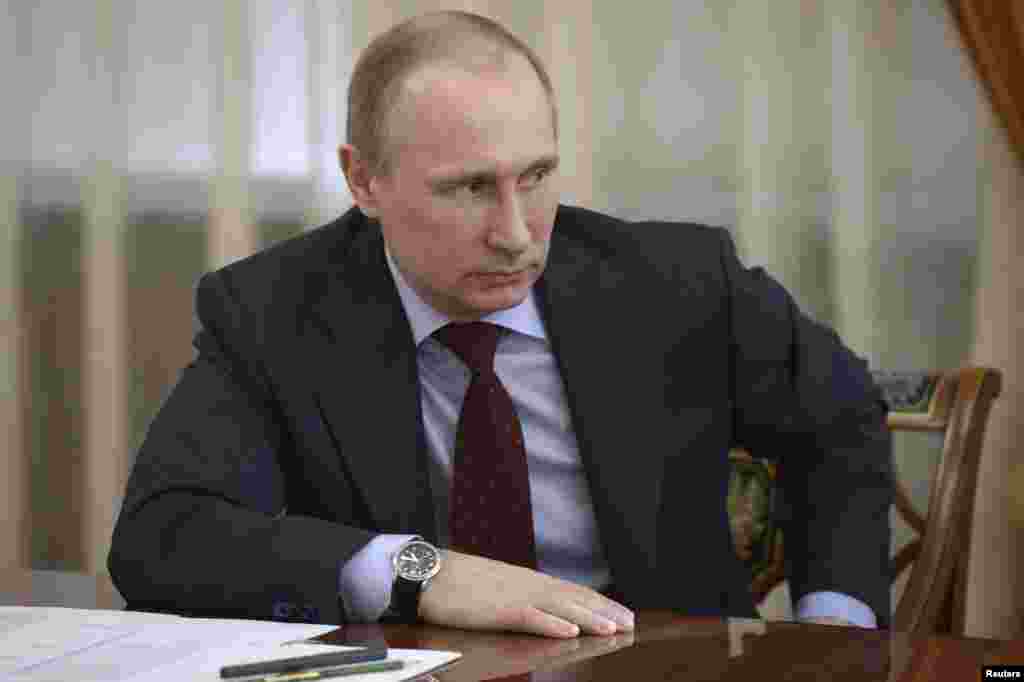 Russian President Vladimir Putin warned the West that curbing Russian use of payment systems based in the U.S. and Europe would backfire, at a meeting with members of the Federation Council, Moscow, Russia, March 27, 2014.