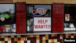 FILE: A help wanted sign is posted at a taco stand in Solana Beach, California. Taken July 17, 2017.