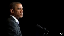 President Barack Obama pauses during speech at the general session of the Democratic National Committee meeting, Washington, Feb. 28, 2014.