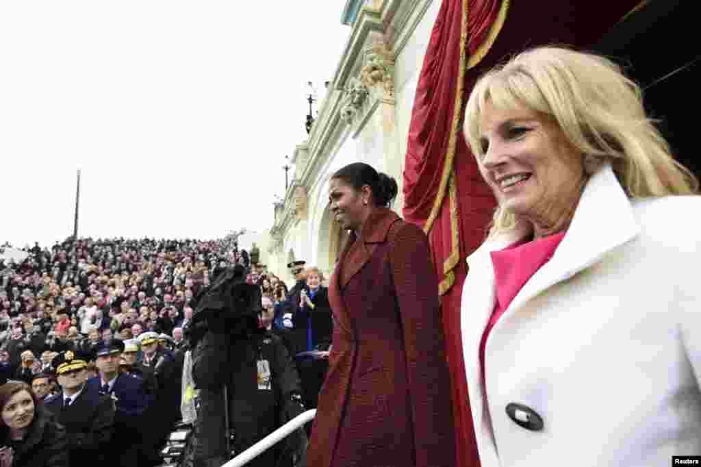 First lady Michelle Obama and Jill Biden arrive on Capitol Hill in Washington, Friday, Jan. 20, 2017, for the presidential inauguration of Donald Trump. (Saul Loeb/Pool Photo via AP)