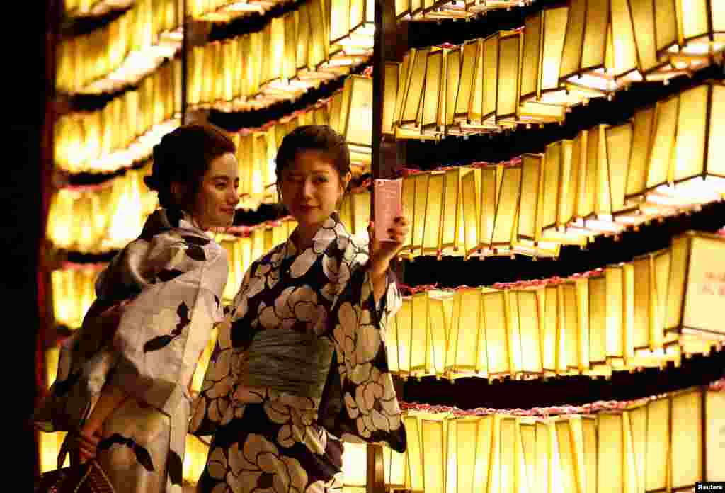 Women in yukatas, or casual summer kimonos, take a selfie in front of paper lanterns during the annual Mitama Festival at the Yasukuni Shrine, where more than 2.4 million war dead are enshrined, in Tokyo, Japan.