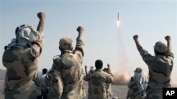 FILE - Iranian Revolutionary Guards celebrate after a missile is launched in Iran, July 3, 2012. Kurdish rebels on Friday clashed with Iran's Revolutionary Guards for a second consecutive day in a border area between Iraq and Iran.