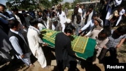 FILE - Afghans take part in the burial of an Afghan journalist in Kabul, Afghanistan, June 7, 2016. On Friday, a roadside bomb killed one journalist and wounded another. In Afghanistan, 2016 is the deadliest year yet for journalists.