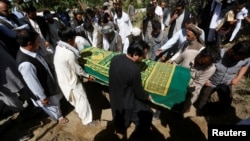 FILE - Afghans take part in the burial of an Afghan journalist in Kabul, Afghanistan, June 7, 2016. Ten journalists have been reported killed in the first half of 2017.