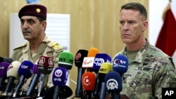 U.S. Army Col. Ryan Dillon, right, spokesman for Operation Inherent Resolve, the U.S.-led coalition against the Islamic State group, and Iraq armed forces spokesman Gen. Yahyah Rasul hold a press conference in Baghdad, Iraq, Sept. 21, 2017.