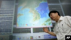 FILE - In this Aug. 28, 2006, photo, Heon-Cheol Chi, of the Korea Earthquake Research Center, explains his concerns of a possible nuclear test in North Korea in Daejon, South Korea.