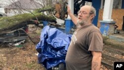 Harley Kelso, 60, speaks while standing outside of his tornado-damaged home in Mayfield, Ky., Dec. 16, 2021.