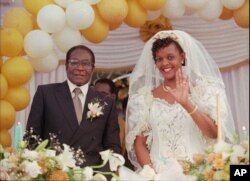 Grace Marufu, the new bride of Zimbabwean President Robert Mugabe, right, waves at guests Saturday, Aug. 17, 1996, after their wedding ceremony at the Kutama catholic mission 42 miles, (80kms )west of Harare.