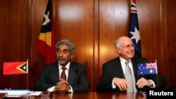 FILE - Australian Prime Minister John Howard (R) and his East Timorese counterpart Mari Alkatiri sit together in Sydney as they await a signing ceremony for the Treaty on Certain Maritime Arrangements in the Timor Sea, Jan. 12, 2006.