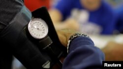 FILE - A man has his blood pressure checked at the Remote Area Medical Clinic in Wise, Virginia, U.S., July 22, 2017.