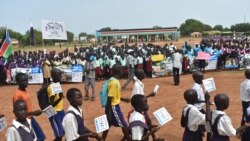 FILE- Students and education officials participate in a get-back-to-school campaign launched in Imatong state, South Sudan, June 7, 2017. (VOA)