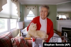 Mary Derr, 93, with her robot cat she calls "Buddy" in her home she shares with her daughter Jeanne Elliott in South Kingstown, Rhode Island.