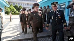 In this photo provided by the South Korea Defense Ministry, North Korean Lt. Gen. An Ik San, center, crosses to southern side for the meeting with South Korea at the border village of Panmunjom, South Korea, July 31, 2018. 