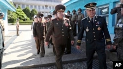 In this photo provided by the South Korea Defense Ministry, North Korean Lt. Gen. An Ik San, center, crosses to southern side for the meeting with South Korea at the border village of Panmunjom, South Korea, July 31, 2018.