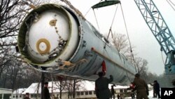 Soldiers prepare to destroy a ballistic SS-19 missile in the yard of the largest former Soviet military rocket base in Vakulenchuk, Ukraine.