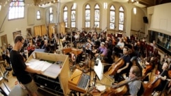 In this Oct. 21, 2019, photo, conductor David Shipps, front left, directs the orchestra during the recording of a video game soundtrack in Nashville, Tenn.