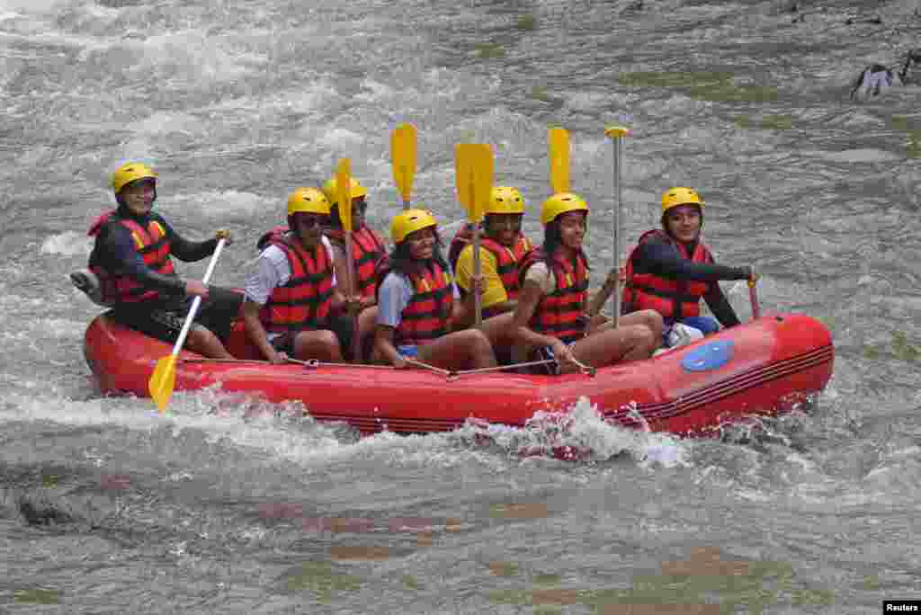 Former United States President Barack Obama (2nd L), his wife Michelle (3rd L) along with his daughters Sasha (C) and Malia (2nd R) go rafting while on holiday in Bongkasa Village, Badung Regency, Bali, Indonesia in this photo taken by Antara Foto.