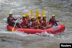 Former United States President Barack Obama (2nd L), his wife Michelle (3rd L) along with his daughters Sasha (C) and Malia (2nd R) go rafting while on holiday in Bongkasa Village, Badung Regency, Bali, Indonesia June 26, 2017.